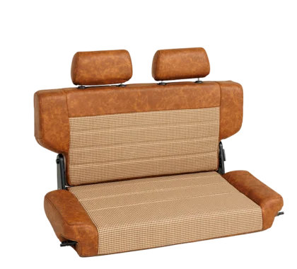 A vintage-style car seat with tan leatherette trim and a brown and white houndstooth fabric insert, featuring two headrests.